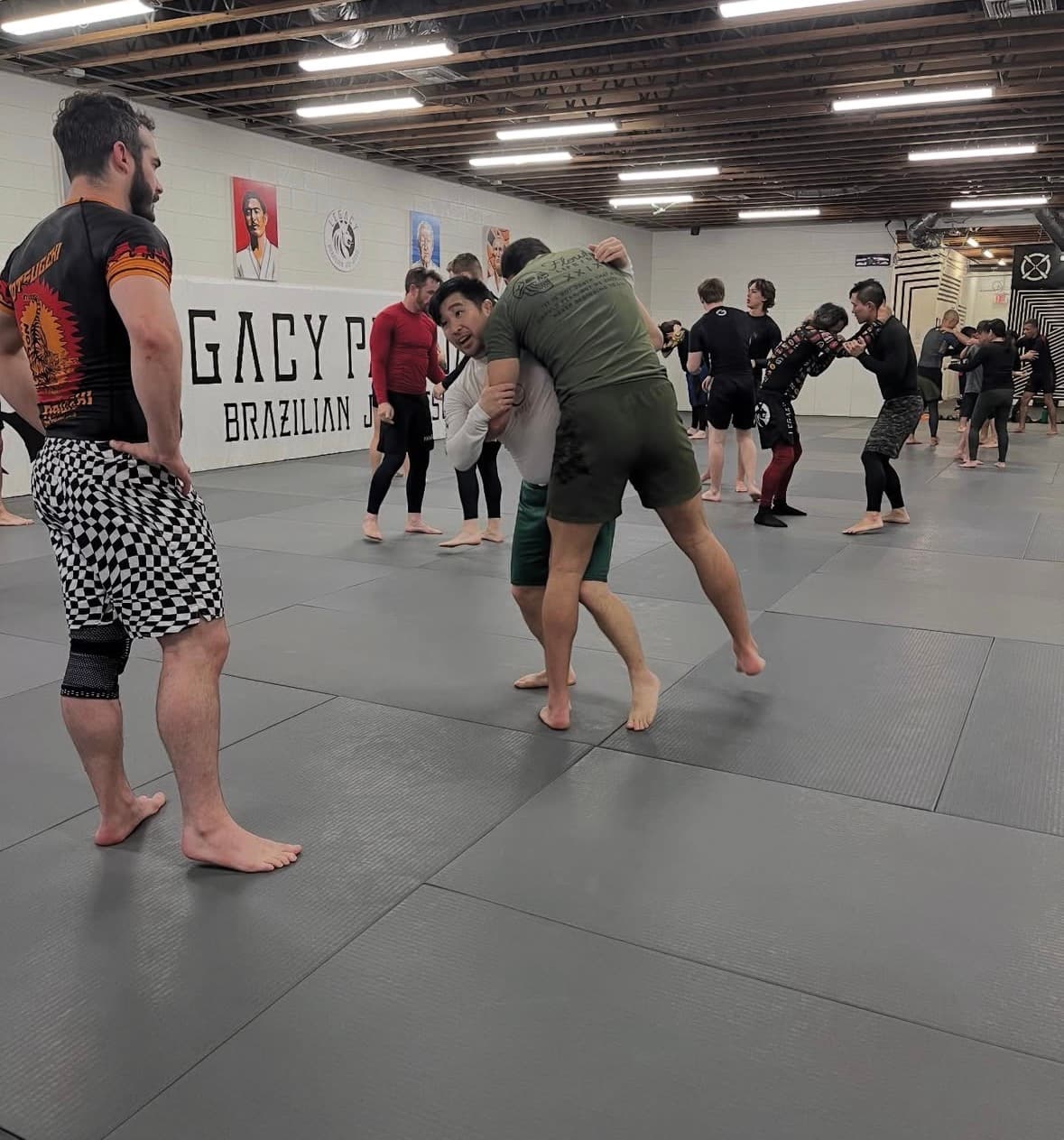 Adult BJJ class rolling on the mats in Pasadena
